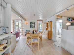 a kitchen and dining room with a table and chairs at Holiday Home Sini - 300m from the sea by Interhome in Gedser +16 photos