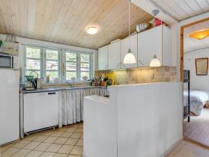 a kitchen with white cabinets and a sink at Holiday Home Sini - 300m from the sea by Interhome in Gedser