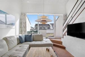 a living room with a couch and a flat screen tv at JB129-Brovst-Strandvejen-150-Lejl-106 in Tranum Strand