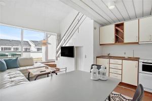 a kitchen and a living room with a table at JB129-Brovst-Strandvejen-150-Lejl-106 in Tranum Strand