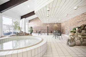 a room with a swimming pool and a brick wall at JB129-Brovst-Strandvejen-150-Lejl-106 in Tranum Strand