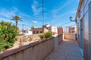 a walkway to a balcony with a view of the city at Antique Spanish Villa With A Patio in Guardamar del Segura