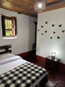 a bedroom with a bed with bats on the wall at Mi casa amarilla in El Rosal