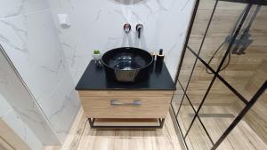 a bathroom with a black sink on a black counter at Comfort Corner Spacious & Quiet 2BR Apartment in Thessaloniki in Thessaloniki +15 photos