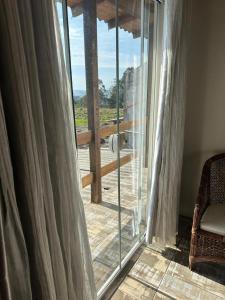 a room with a sliding glass door with a view at Hotel e Restaurante Santa Fé in Lages