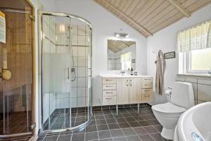 a bathroom with a shower and a toilet and a sink at JB223-Brovst-Kronvildtvej-18 in Tranum +35 photos