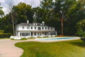 a white house with a swimming pool in front of it at WestWind Estate in Spartanburg