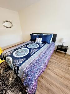 a bedroom with a bed with a blue and purple blanket at Beautiful, Spacious, 22 In Elkins Park in Jenkintown