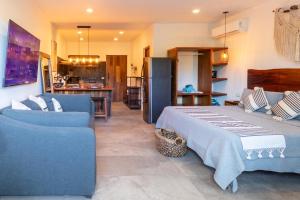 a bedroom with a bed and a couch and a kitchen at TULUM XAMIRA PRIVATE SPA Balcony in Tulum