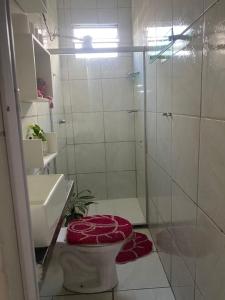 a bathroom with a shower and a toilet and a sink at Villa Zilá in Vila Velha