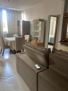 a living room with a couch and a table at Villa Zilá in Vila Velha +5 photos