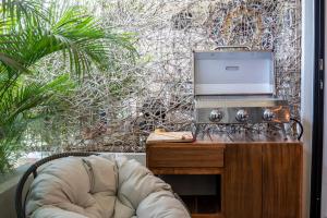 a room with a table with a stove and a chair at TULUM XAMIRA PRIVATE SPA Balcony in Tulum