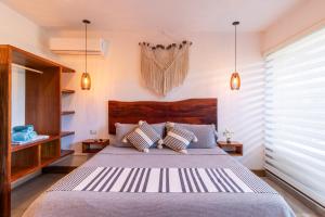 a bedroom with a large bed with two pillows at TULUM XAMIRA PRIVATE SPA Balcony in Tulum +21 photos