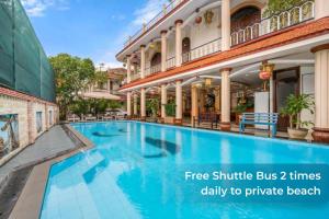 a swimming pool in the courtyard of a building at Sala Hoi An Hotel in Hoi An