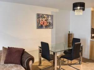 a living room with a glass table and a couch at Spacious 2-Bedroom Ground Floor Flat with 2 Double Beds, Sleeps 4 in Central Aberdeen in Aberdeen