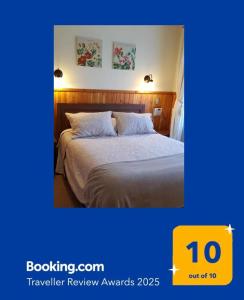 a hotel room with a bed and two pictures on the wall at Departamento Acogedor Parque Suizo 800 Pucon in Pucón
