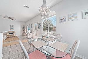 a dining room with a glass table and chairs at Charter Landing A10 in Orange Beach