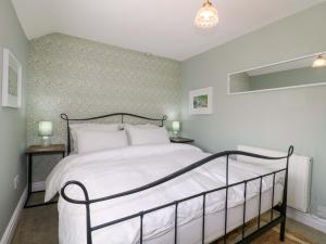 En eller flere senge i et værelse på Prospect Cottage