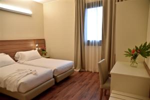 Voodi või voodid majutusasutuse Hotel Forum toas