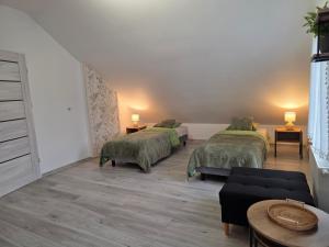 a living room with two beds and a couch at Komfortowy Dom Całoroczny - sauna, jacuzzi, bilard in Tyłowo +52 photos