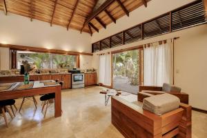 a living room with a desk and a table at Bodhi & Nirvana Houses in Talamanca
