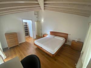 a bedroom with a bed and a wooden floor at Villa Sabina in Lido di Camaiore