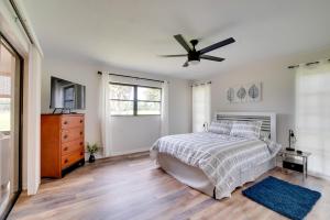 a bedroom with a bed and a ceiling fan at Walk to Lake Geataway with Yard in Inverness in Inverness +18 photos