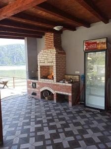 a brick fireplace in a room with a patio at Vila Smeu in Dubova