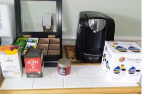 a shelf with a coffee maker and boxes on it at Century House on Quarter acre lot in Acton