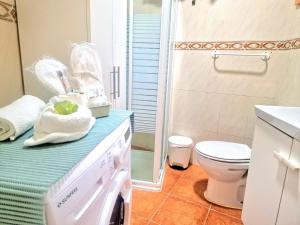 a bathroom with a washing machine on a counter at relaxing country house with wonderful ocean view in Granadilla de Abona +33 photos