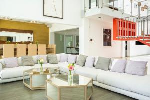 a living room with a white couch and tables at Villa RosMar Luxury Beachfront House in Cozumel