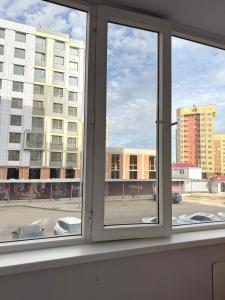 a window with a view of a city street at Near Khan Shatyr in Astana
