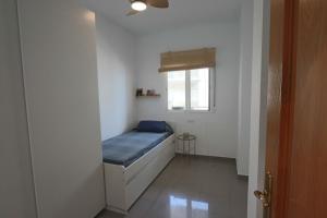 a small room with a bed and a window at Castell Beach - Sea front - parking - swimming pool in Castell de Ferro +29 photos