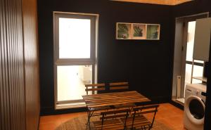 a table and chairs in a room with a window at Casa do Balneario in Arnoia