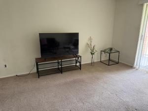a living room with a flat screen tv and a table at Modern 1br Retreat In Elkins Park - Long Term in Jenkintown