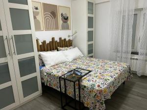 a small bedroom with a bed and a table at Marina Holiday Home in Pizzo