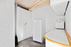 a white room with a refrigerator and a table at JB195-Fjerritslev-Bogevej-36 in Fjerritslev