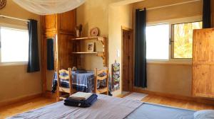 a bedroom with a bed with a suitcase on it at Spellbound in Siwa in Siwa