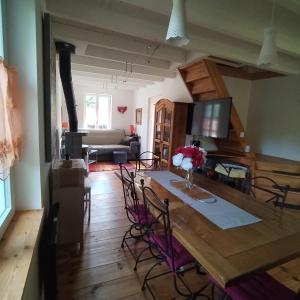 a dining room and living room with a table and chairs at Chalet le Ponderosa in Le Tholy +15 photos