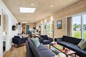 un soggiorno con divani blu e una cucina di JB350-Fjerritslev-Egevej-9 a Fjerritslev