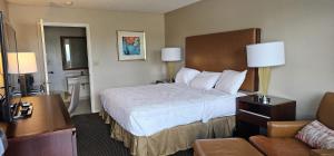 a hotel room with a bed and a couch at Sunrise Inn in Eastman