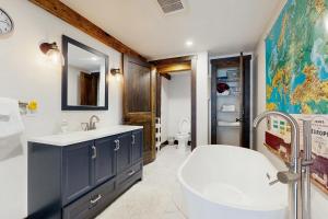 a bathroom with a tub and a sink and a bath tub at Red Barn & Blueberries in Wells +47 photos