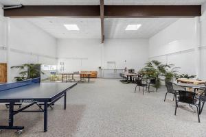 a ping pong table in a room with tables and chairs at JB358-Brovst-Strandvejen-150-Lejl-126 in Tranum Strand