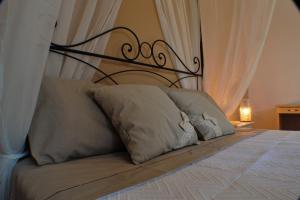 a bed with a black headboard and two pillows at Montammare Casa Di Charme in Tramonti