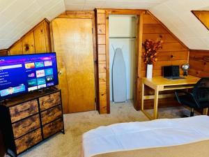 a bedroom with a bed and a desk and a television at Comfortable Private Rooms in Rochester in Rochester