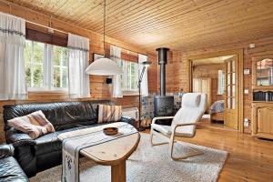 a living room with a leather couch and a table at VGO437-Svenljunga-Oersas-Holm-103 in Enesbo