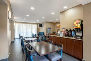 a restaurant with tables and chairs and a counter at Comfort Inn Greenville I-65 in Greenville