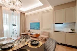 a living room with a glass table and chairs at Palazzo Panfilli Central Luxury in Trieste