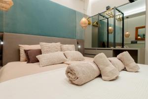 a bedroom with a large white bed with pillows at Palazzo Panfilli Central Luxury in Trieste