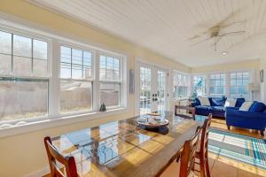 a dining room with a table and chairs and windows at Seas the Day in Wells